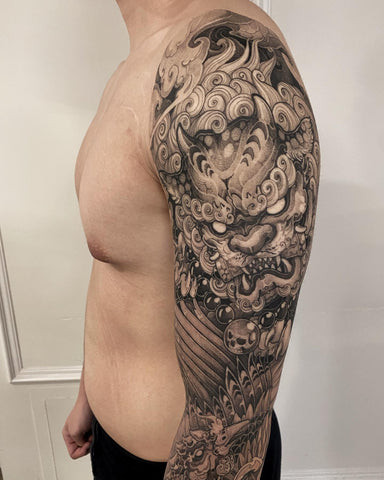 Colorful Foo Dog Tattoo on Thigh with Floral and Cloud Background