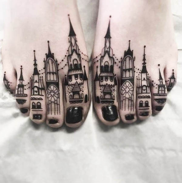 Buildings on the toes foot tattoo, a miniature cityscape design on each toe, showcasing urban creativity