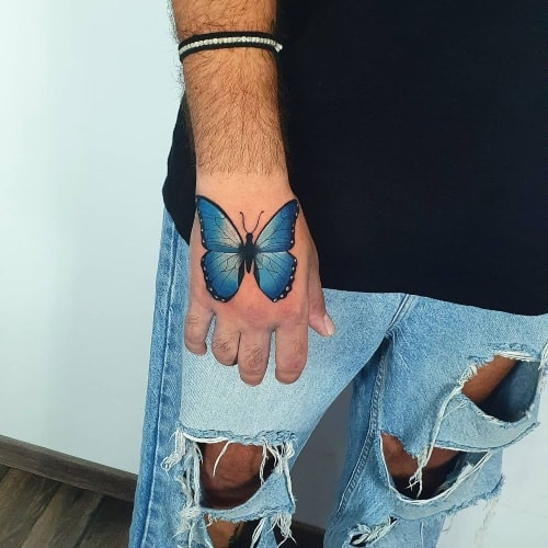 Two butterfly tattoos on men, one on the chest with a stylized butterfly and flowers and another on the shoulder with a geometric butterfly pattern.