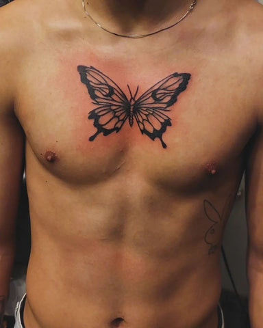 A butterfly chest tattoo with vibrant colors and delicate wings, symbolizing transformation and freedom.