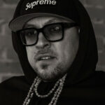 Dean Harden at Anchors End Tattoo, showcasing traditional tattoo artistry and shop ambiance.