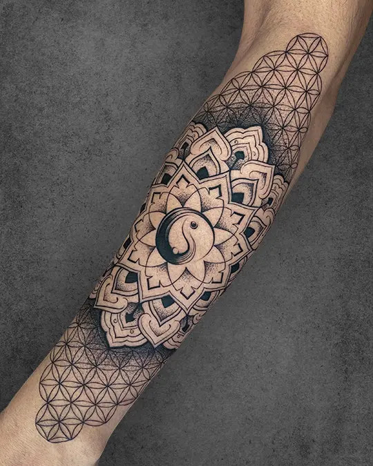 Yin Yang symbol cleverly integrated within a Flower of Life tattoo, representing balanced energies and universal harmony in duality.