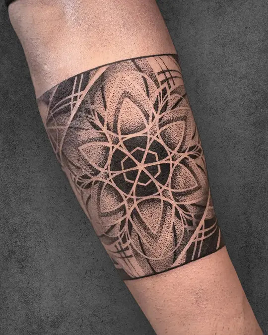 Bold armband Flower of Life tattoo design, encircling the arm in a powerful display of sacred geometry.