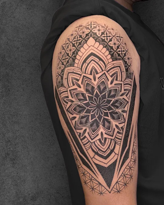 Harmonious blend of mandala art and Flower of Life tattoo on the back, symbolizing spiritual balance and cosmic unity.