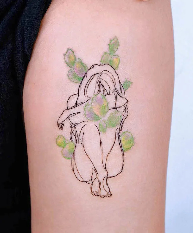 alt text: Unique cactus girl tattoo on arm, depicting a woman with cactus spines as armor, symbolizing endurance and self-reliance