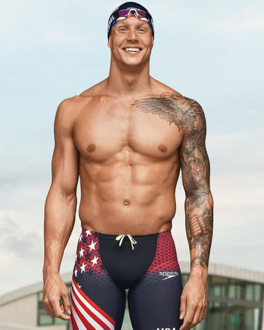 Caeleb Dressel showcasing his sleeve tattoo featuring nautical and patriotic themes