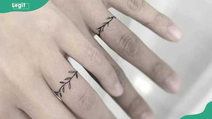 Floral patterns wedding ring tattoos symbolizing growth and blossoming love.