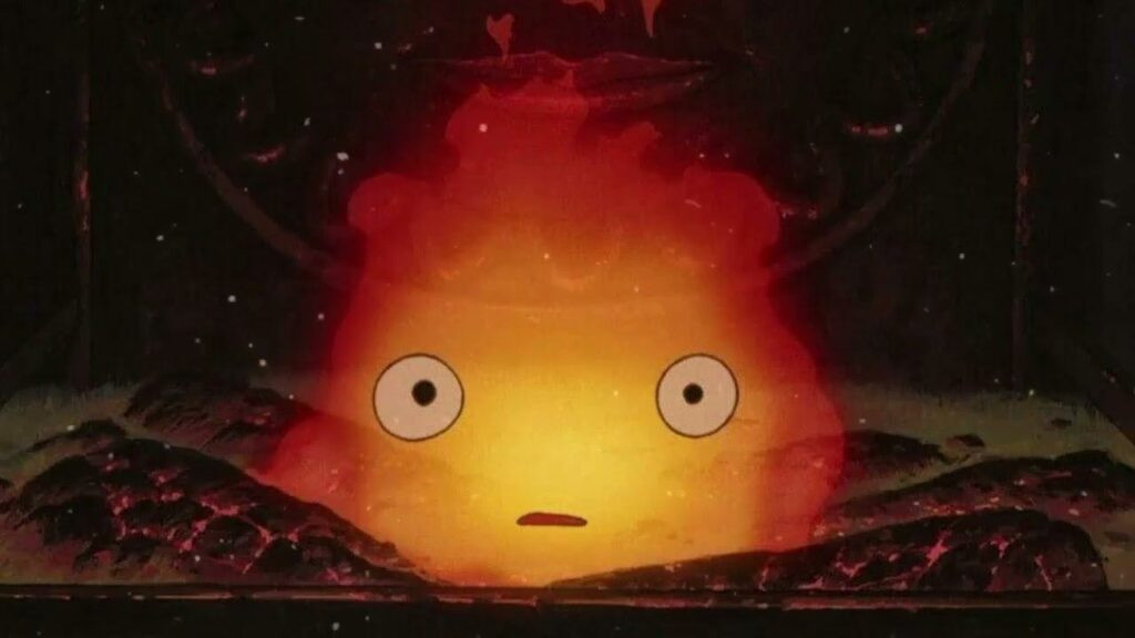 Close-up of Calcifer from Howl's Moving Castle, a small fire demon with expressive eyes and a playful grin.