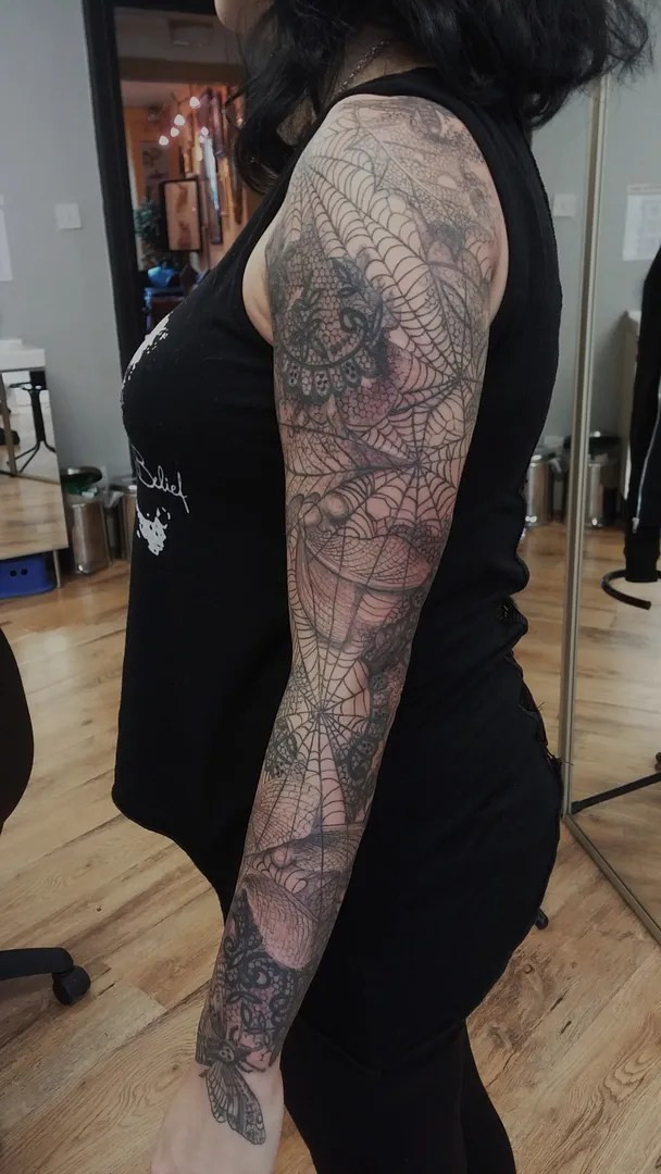 Cobweb tattoo sleeve in progress showcasing the intricate line work and shading