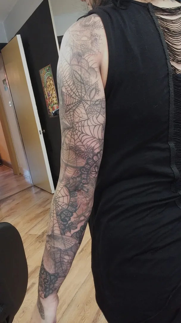 Full view of the completed cobweb tattoo sleeve highlighting the overall design and placement on the arm
