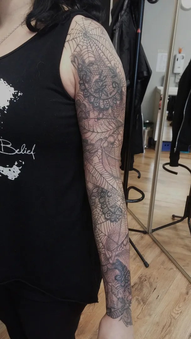 Detailed section of the cobweb tattoo displaying the texture and depth achieved through black and grey ink