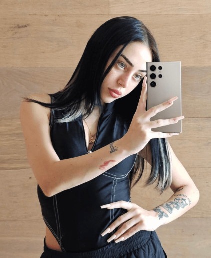 Peso Pluma's 'Felix the Cat' tattoo, speculated to be inspired by his relationship with Nicki Nicole and her similar tattoo.