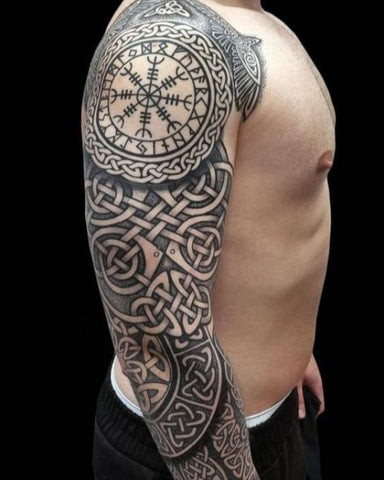 Celtic sleeve tattoo featuring intricate knotwork and Celtic symbols in black ink