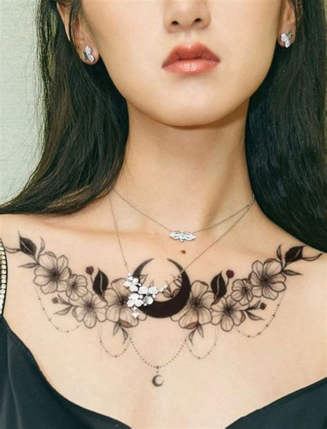 Elegant chest tattoo ideas for women featuring floral and bird designs