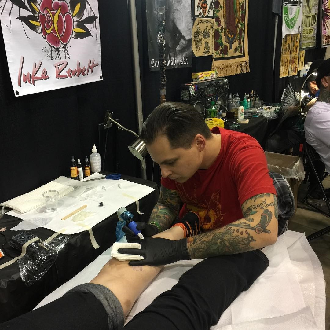 Fresh netherworld priest tattoo on a wrist, part of a Beetlejuice sleeve, at Chicago Tattoo Con