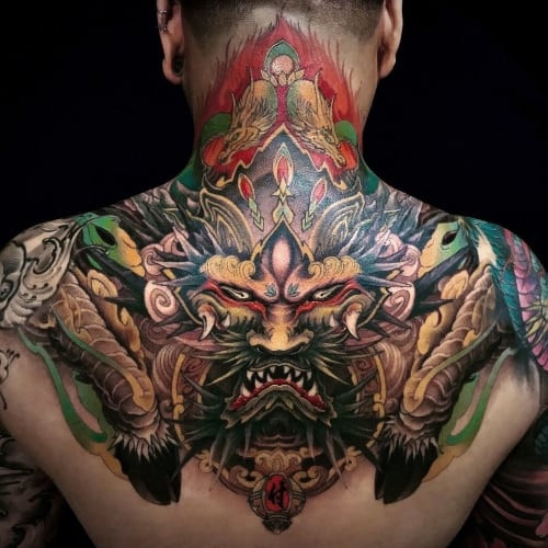 A Chinese dragon tattoo with vibrant colors on a man's arm, symbolizing strength and fortune