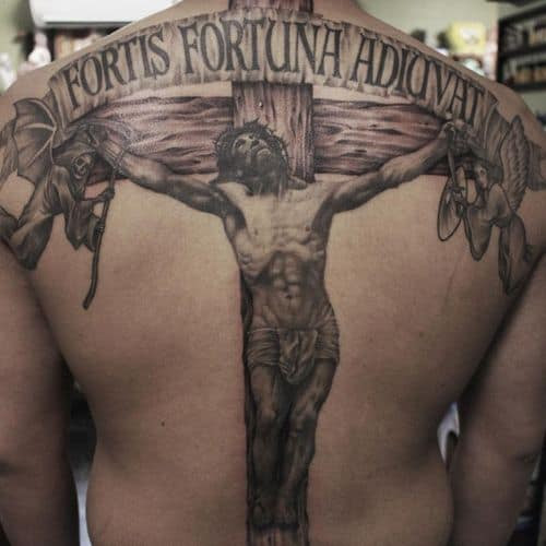 A detailed Christian tattoo featuring religious iconography on a man's back, expressing deep devotion