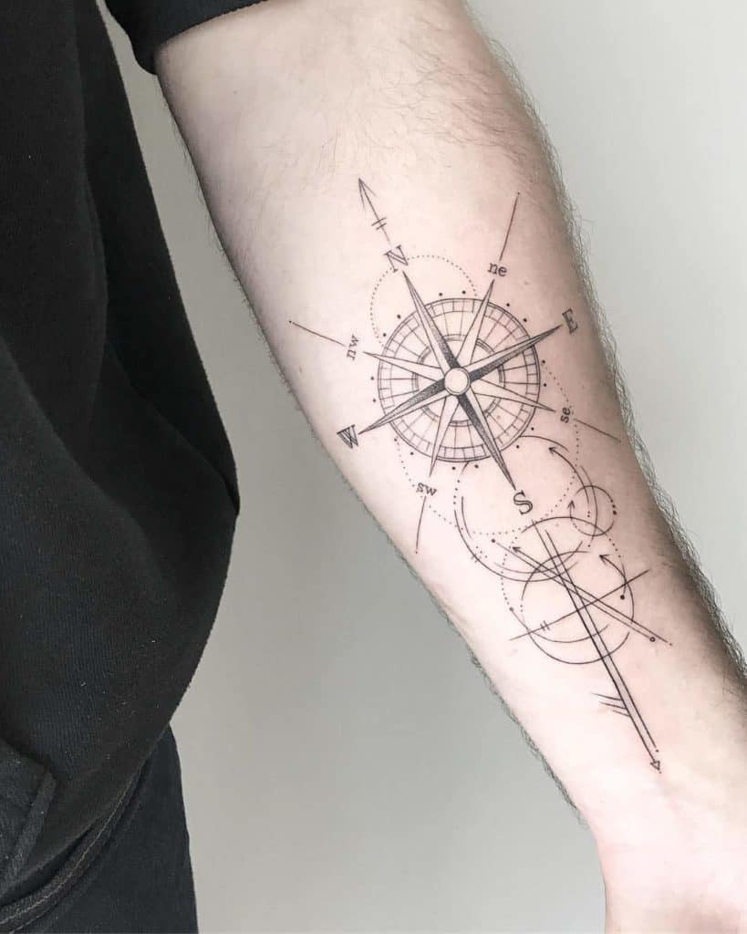 Fine line compass arrow tattoo for guidance and direction