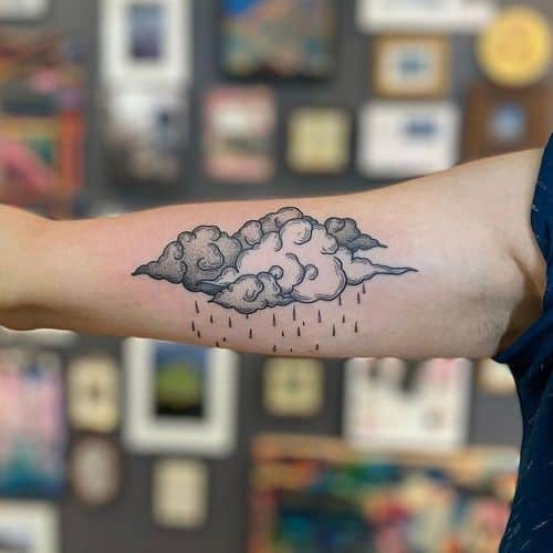 Japanese style cloud tattoo with bold outlines and vibrant colors on a man's back