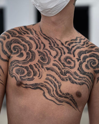 Cloud chest tattoo with soft shading, symbolizing dreams, freedom, and spirituality.