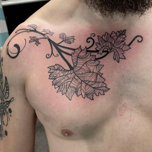 A collarbone tattoo with lettering along the clavicle on a man, subtle and elegant