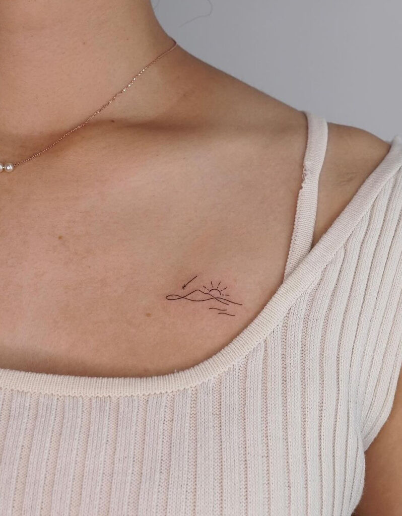 Mountain, sun, and ocean tiny collarbone tattoo