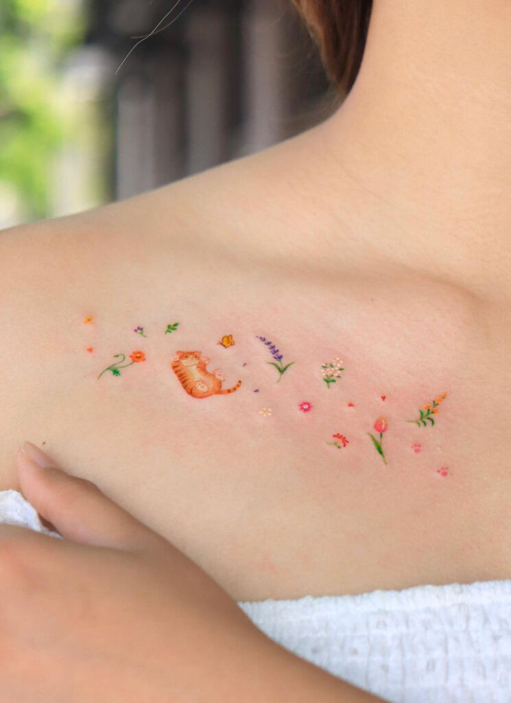 Cats, flowers, and butterflies colored collarbone doodle tattoo