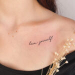 “love yourself” cursive collarbone tattoo