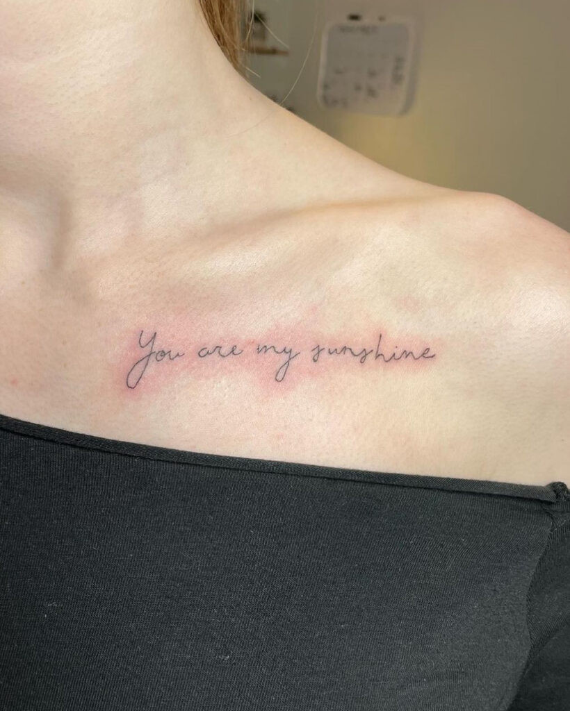 “You are my sunshine” cursive collarbone tattoo