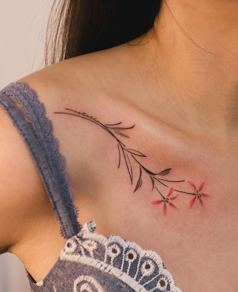 Black &amp; red flowers collarbone tattoo