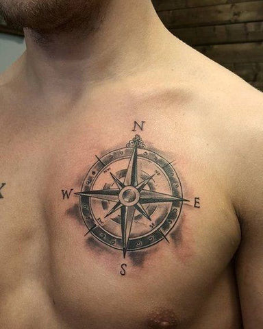 Compass chest tattoo with highlighted details, symbolizing direction, journey, and adventure for adventurers.