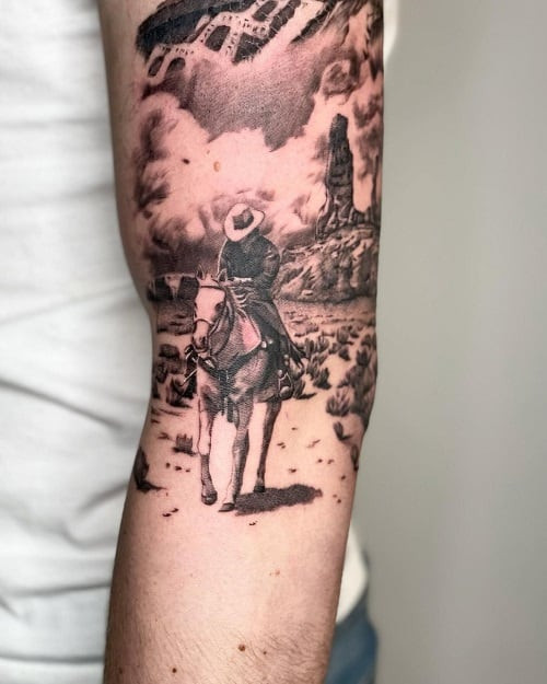 Detailed cowboy portrait tattoo on shoulder