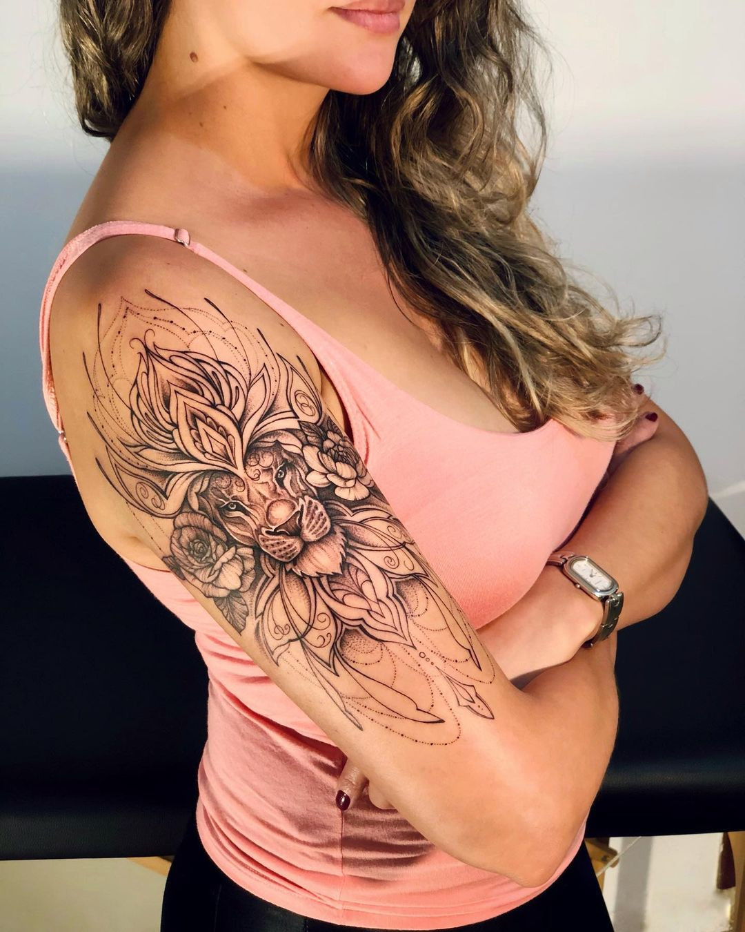 Unique lion tattoo for women, abstract line work and floral integration for a creative design