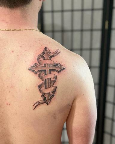 Geometric style cross tattoo on a man's back, incorporating sharp lines and modern aesthetic.