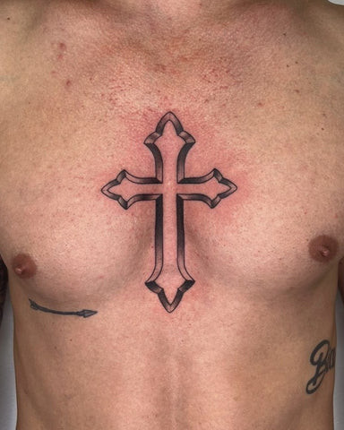 Simple black cross tattoo on a man's chest, centered and minimalist design.