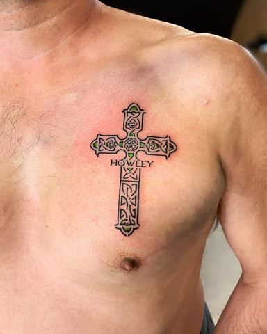 3D style cross tattoo on a man's chest, creating depth and visual interest.