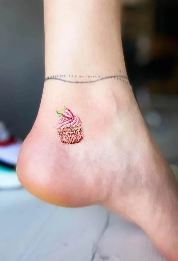 Cute cupcake foot tattoo, a playful and adorable design showcasing a love for sweets and a cheerful personality