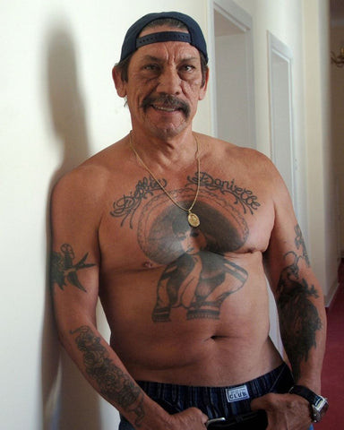 Danny Trejo's iconic chest tattoo of a woman wearing a sombrero, symbolizing his Mexican heritage and life journey.