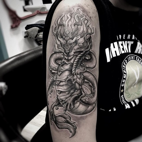 Dragon tattoo spanning across the arm