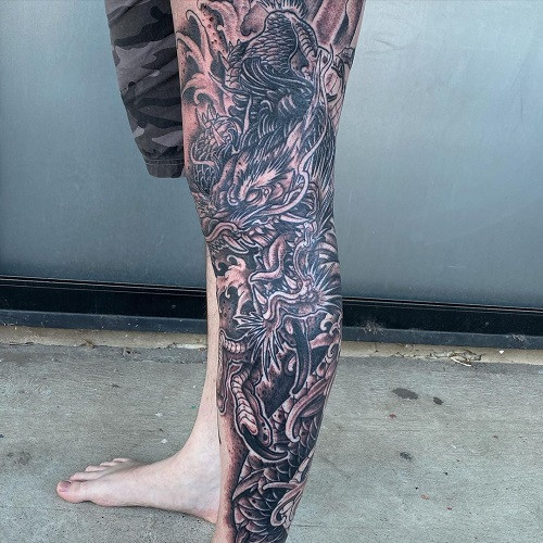 Dragon tattoo wrapping around the leg