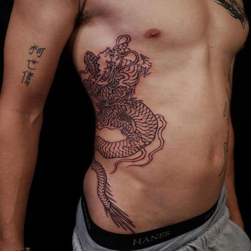 Japanese dragon tattoo with vibrant colors on the back, showcasing elaborate men tattoo ideas.