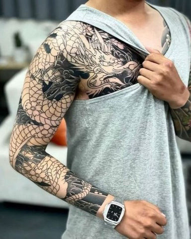 Dragon sleeve tattoo featuring a serpentine dragon wrapped around the arm in vibrant colors