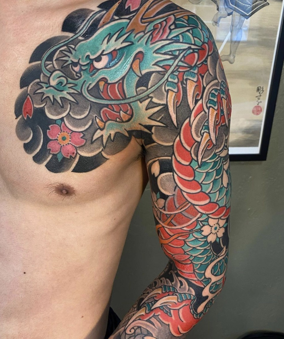 Full dragon tattoo sleeve design on arm