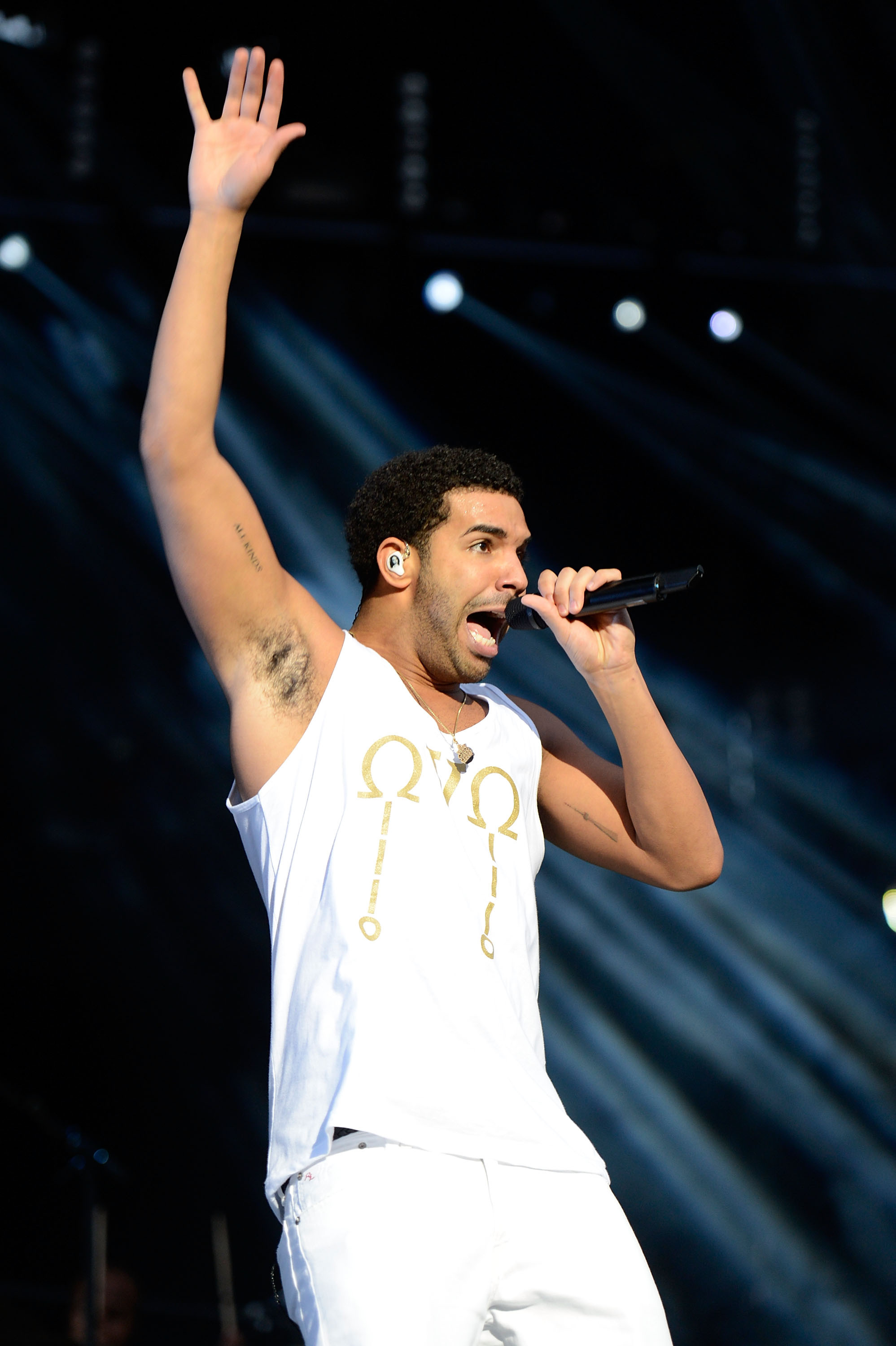 Drake performing with Toronto-related tattoos visible