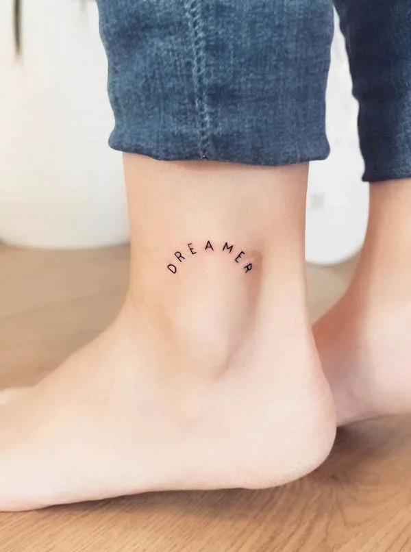 Dreamer word foot tattoo, a sleek and powerful representation of identity, goals, and values