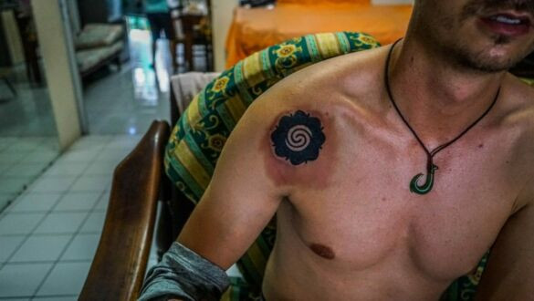 The author proudly displaying his new traditional Iban hand tattoos - Bungai Terung and fish hook.