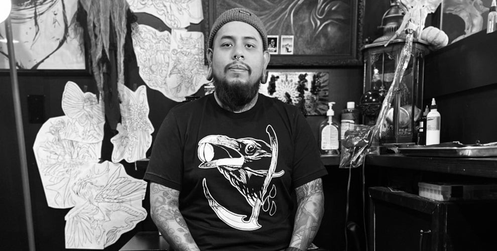 Renowned tattoo artist Emmanuel Mendoza, creator of the Death Wish Coffee tattoo design, pictured in his Ohio studio. Explore his unique coffee tattoo art.