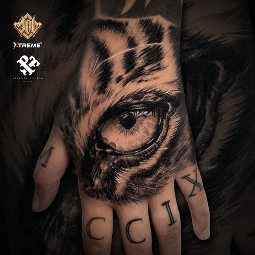 Focused eye of the tiger tattoo symbolizing determination