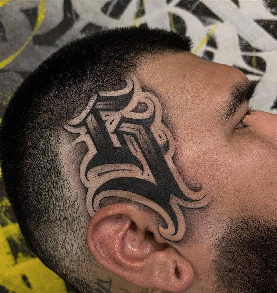 Honeycomb pattern face tattoo extending across the forehead and temple, a unique and cool geometric design.