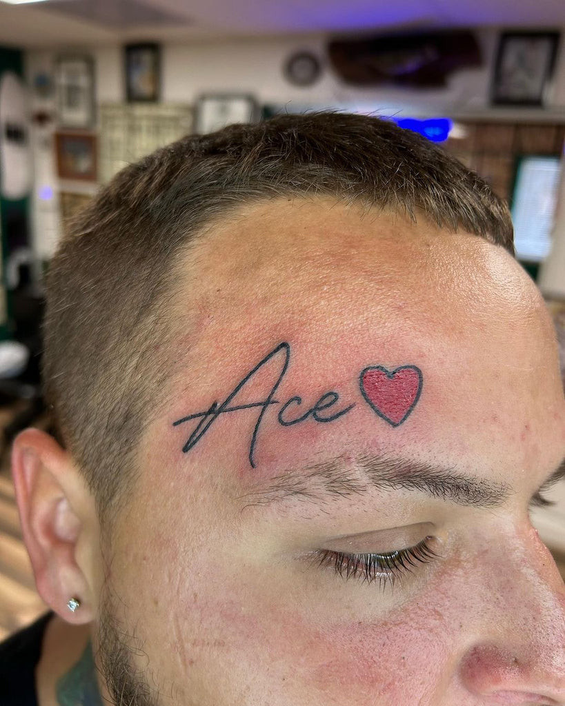 Minimalist line face tattoo forming a geometric shape on the forehead, a cool and contemporary design choice.